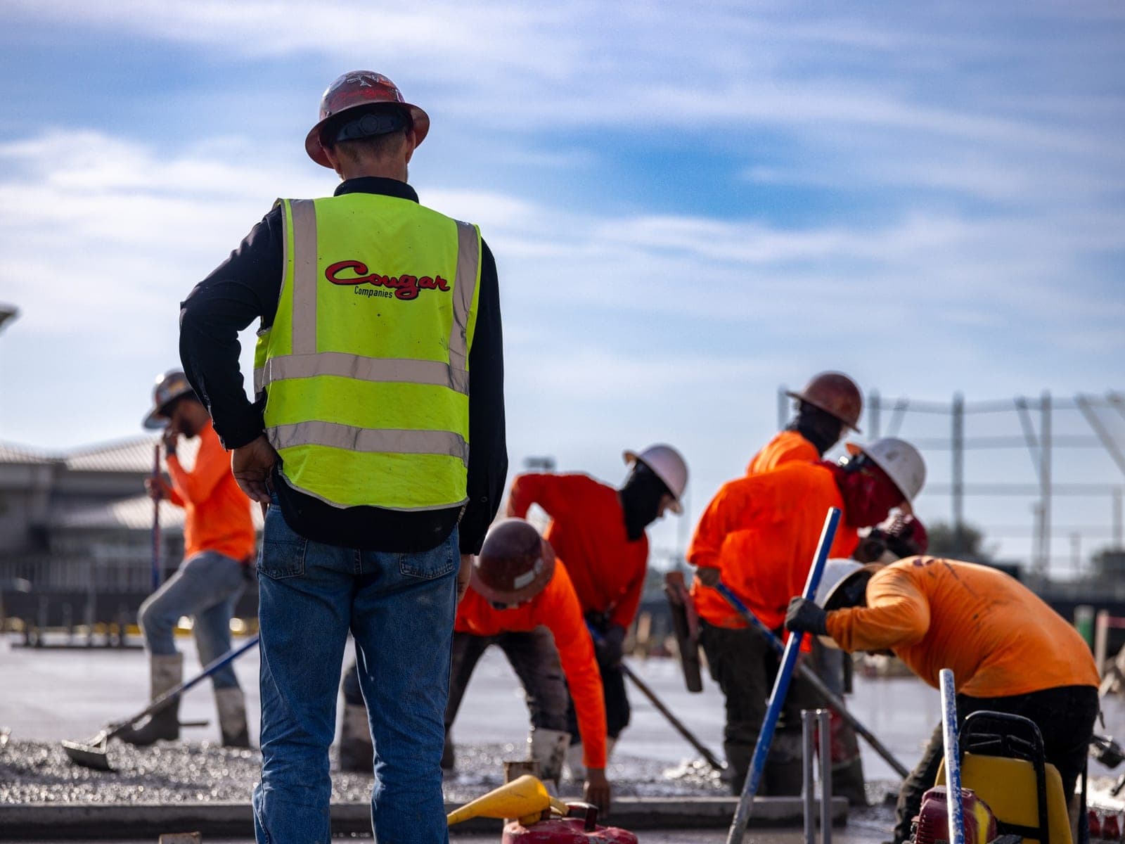A Cougar Companies crew placing and finishing a concrete slab